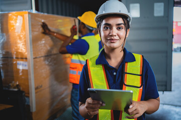 Female worker wearing safety equipment to control work in heavy industrial plant industrial factory warehouse Inspection quality control