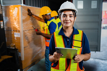 A female worker inspects goods in a warehouse. African American engineer in an industrial...