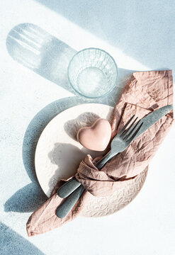 Valentine's Day table with heart crystal decor placed on concrete surface at kitchen table