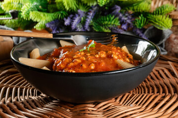 Wholegrain penne pasta with bolognese sauce.