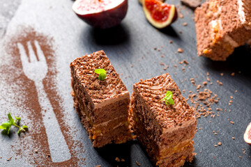 Chocolate cake cut into square pieces with nut cream
