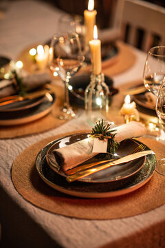 winter holidays, dinner party and celebration concept - close up of scandinavian christmas table serving with burning candles at home at night
