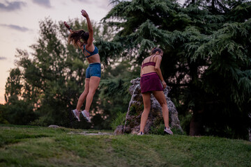 Friends Enjoying Evening Fun at the Park Splash Fountain