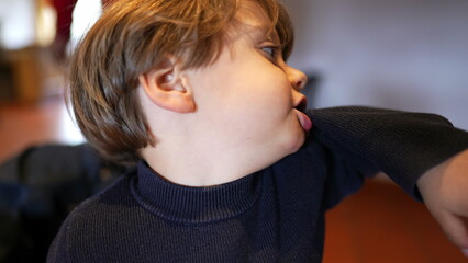 Idle Antics - Little Boy Biting Sleeve, Expressing Boredom While Waiting at Restaurant