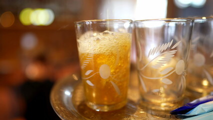 Serving Ritual - Pouring Fresh Tea into Glass Cup at Restaurant