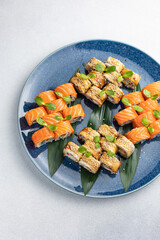 Japanese cuisine. Delicious fried rolls with salmon