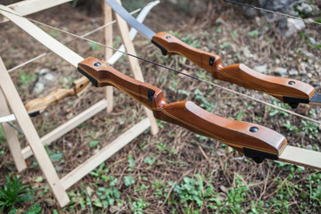 Wooden bows displayed over folding sawhorses