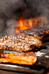 Juicy meat steaks and fillets are grilled