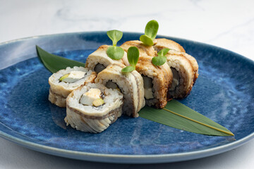 Japanese cuisine. Handmade sushi rolls with eel
