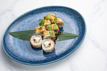 Japanese cuisine. Handmade sushi rolls with eel
