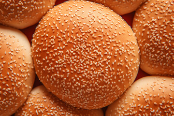 Surround a hamburger bun with a sesame seed coating.