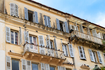 Fototapeta na wymiar Residential building with overhead power lines and antennas in the old town of Corfu on the island of Corfu