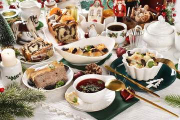 Christmas Eve table with traditional Polish dishes and pastries
