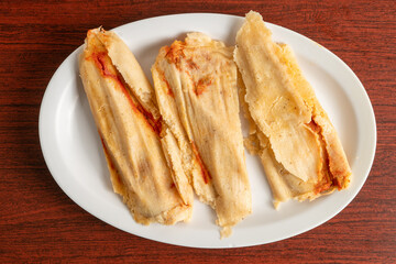 Three Mexican tamales on a plate