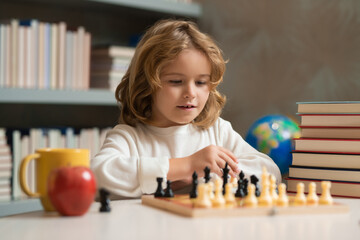 Chess school. Concentrated child play chess. Kid playing board game in classroom. Games good for...