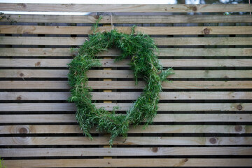Rosemary wreath against wooden fence