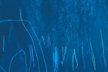 Chaotic abstract drawing pattern crayon blue cold color surface school dirty chalkboard close-up