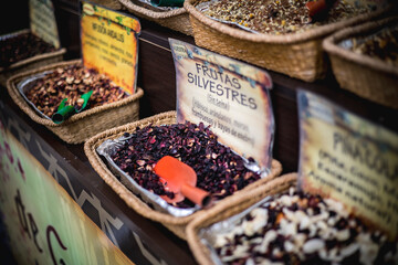 close up view of baskets with different kinds of tea in a herbal shop