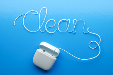 Dental floss in the shape of the word CLEAN on a blue background. 3d render