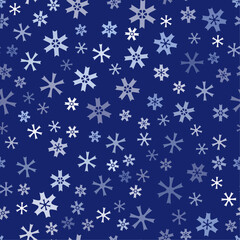 Many small irregular snowflakes on blue background. Seamless pattern with snowflakes. Snowflake ornament vector illustration. Decorative design element.  Winter mood.