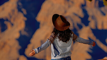 Young woman enjoying the incredibly impressive view over the majestic Grand Canyon - travel...