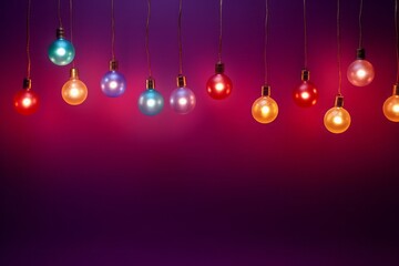 Colorful Christmas light bulbs on a purple background with copy space.