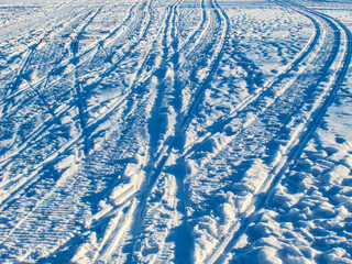 traces of skis and snowmobiles on the snow, ski tracks and winter