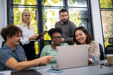 Happy businesspeople collaborating on a new project in an office