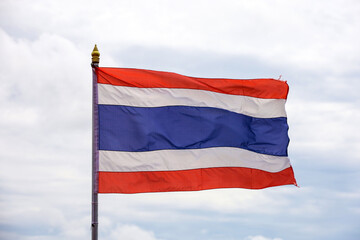 Fototapeta na wymiar The national flag of the Kingdom of Thailand is waving against the sky with clouds