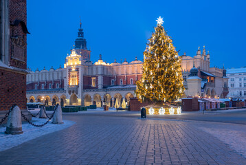 Krakow, Poland, Main Market square and Cloth Hall in the winter season, during Christmas fairs decorated with Christmas tree.