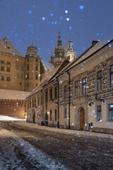 Wawel castle and Wawel cathedral from kanonicza street during snowfall in the night, Krakow, Poland - 683046315