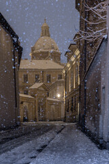 Saints Peter and Paul church over Poselska street, snowy night, Krakow old town, Poland