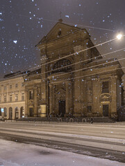 Baroque Vincentians church on Stradom street during snowy night, Krakow, Poland