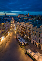 Main Square and Grodzka street illuminated in the night, Krakow, Poland