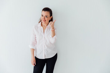 Beautiful woman in business suit in office showing hand direction