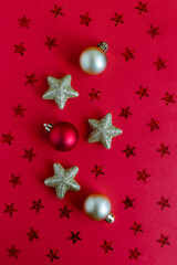 Beautiful Christmas ornaments on a bright red background with stars.