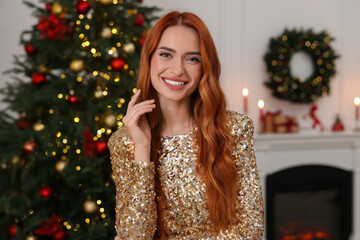 Happy young woman in room decorated for Christmas