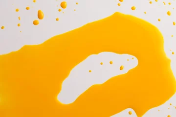 Schilderijen op glas Ink Watercolor flow blot drops splash. Abstract texture Yellow orange color stain background. © Liliia