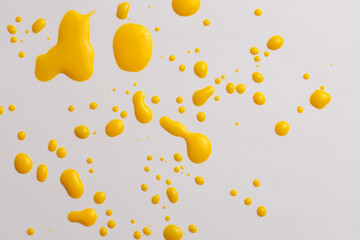 Ink Watercolor flow blot drops splash. Abstract texture Yellow orange color stain background.