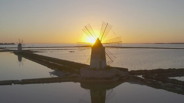 Sunset at Windmills in the salt evoporation pond in Marsala, Sicily island, Italy
Trapani salt flats and old windmill in Sicily.
View in beautifull sunny day.