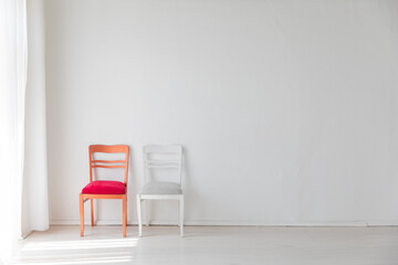 Two vintage chairs in the interior of a white room