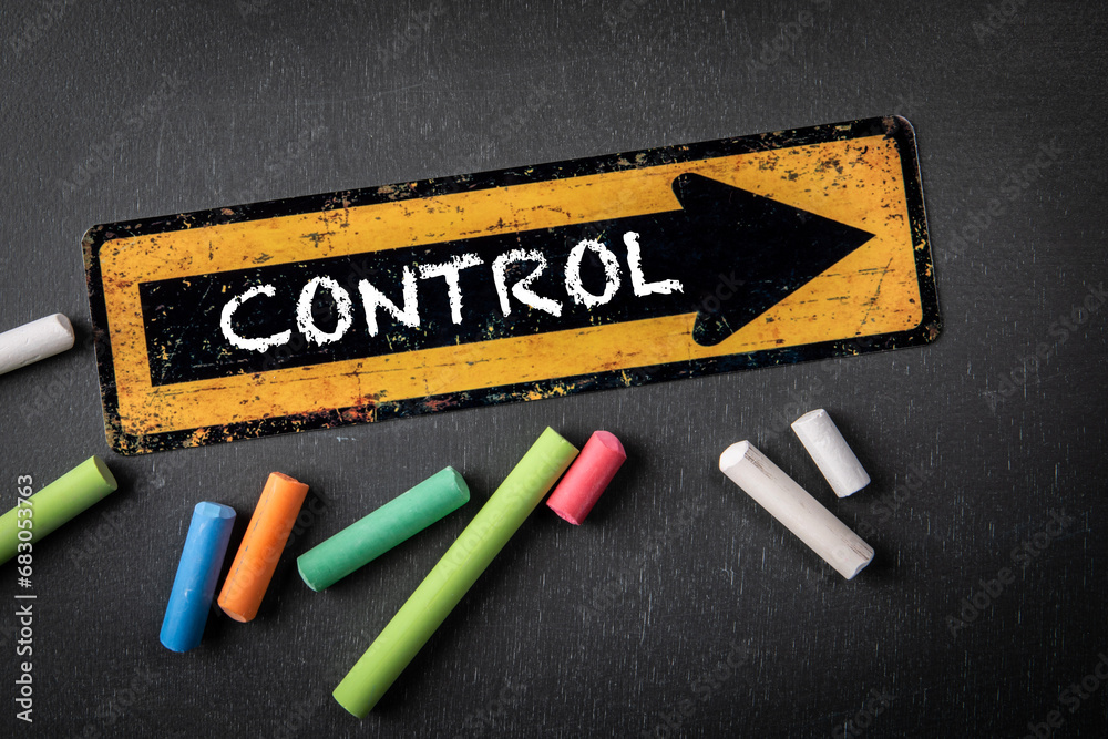 Wall mural control concept. direction arrow with text on a dark chalkboard background