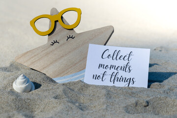 COLLECT MOMENTS NOT THINGS text on paper greeting card on background of funny starfish in glasses...