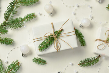 Christmas beautiful composition with pine twigs, gifts and beads on white background