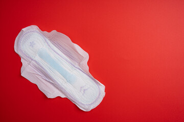 Menstrual pad for women on red background