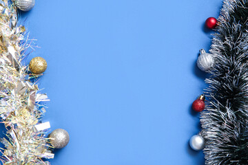 Composition with tinsels and Christmas balls on blue background
