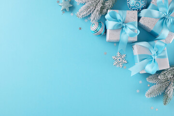 Begin your merry Christmas shopping quest. Top view photo of festive gift boxes, yule tree ornaments, frosty fir branches, snowflakes on blue background with advert space - obrazy, fototapety, plakaty