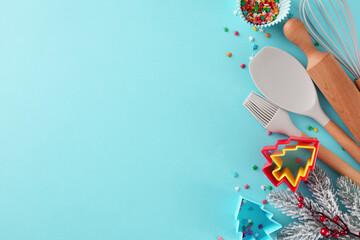 Process behind creating holiday sweets concept. Top view shot of candies, baking tools, baking molds, frosty fir twigs, colorful stars on blue background with promo area