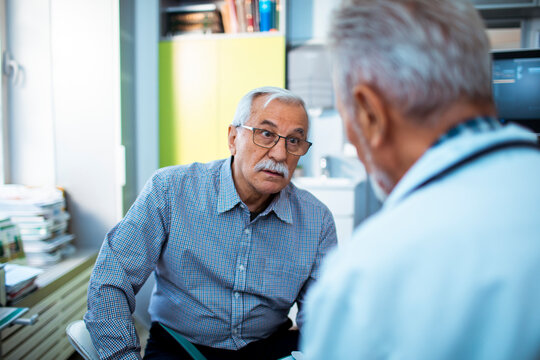 Senior Patient Discussing Health with Doctor in Clinic