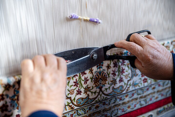 weaving carpet ,a diligent woman makes a traditional carpet by hand , Loom for hand weaving carpet...